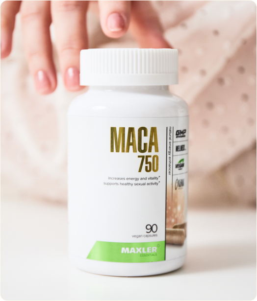 A photo of fingers touching MACA 750 bottle.