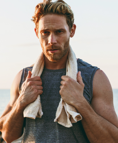 A photo of a man with a towel.