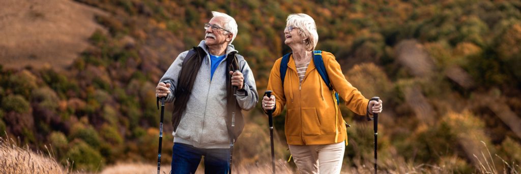 Two elderly people hiking