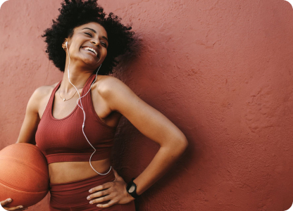 A woman with headphones and basketball ball