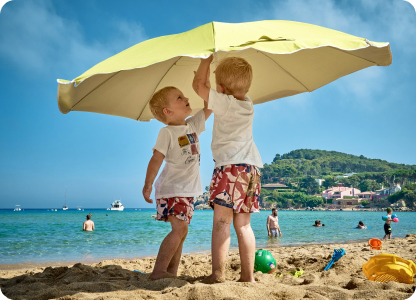Two boys under the beach umbrella