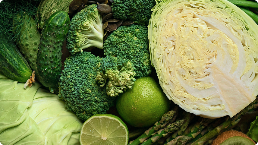 Assortment of green vegetables like broccoli, cabbage, and asparagus, all rich in vitamin C